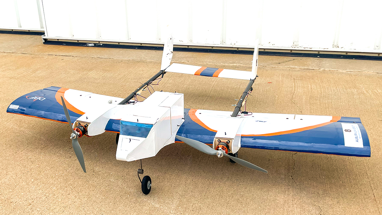 A remote-controlled plane sitting on the ground.