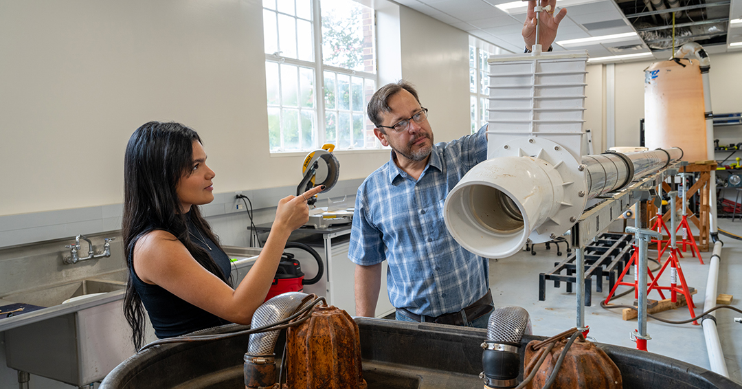 Civil and environmental engineering doctoral student Maria Luisa Lobo, left, and Jose Vasconcelos, professor of water resources, work with experimental water infrastructure in an Auburn laboratory.