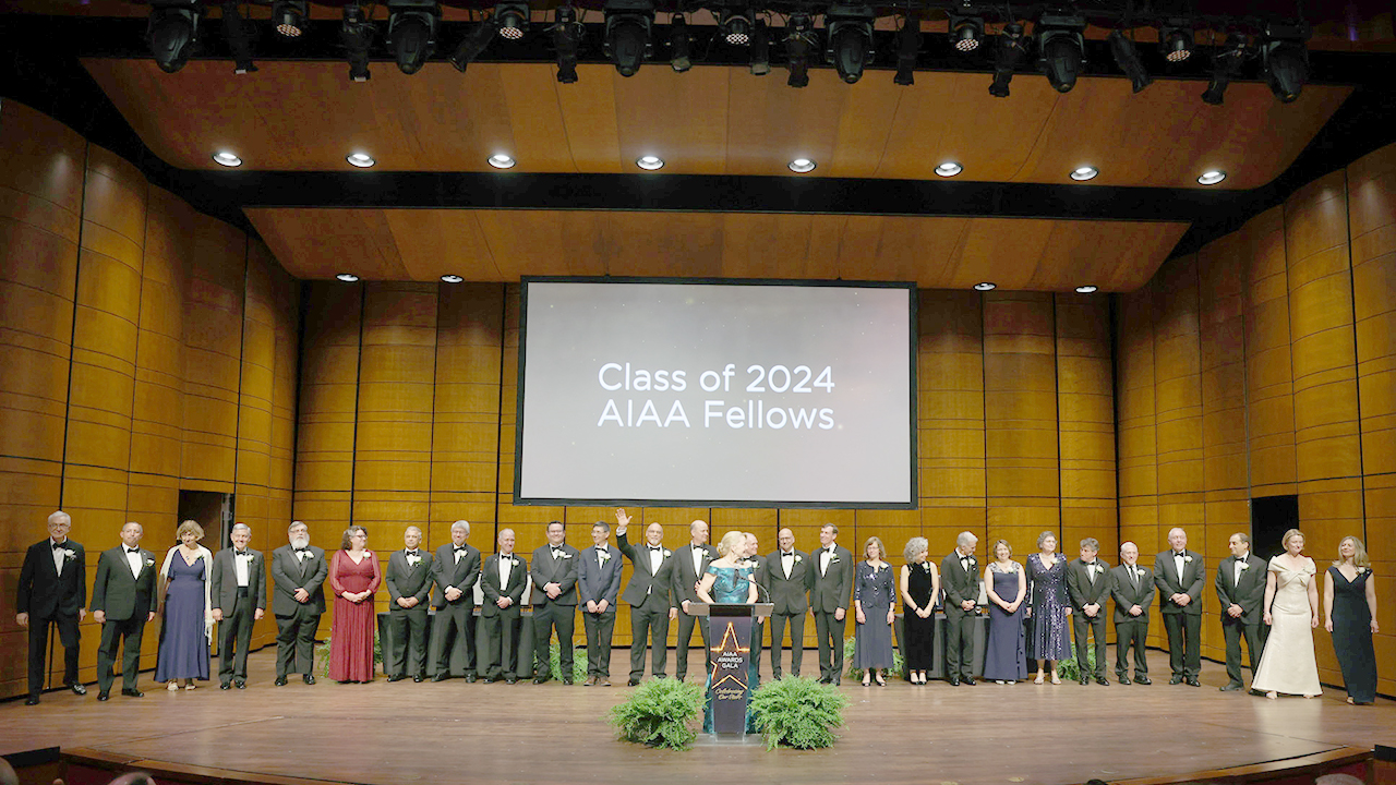 Several people on a stage at a gala.