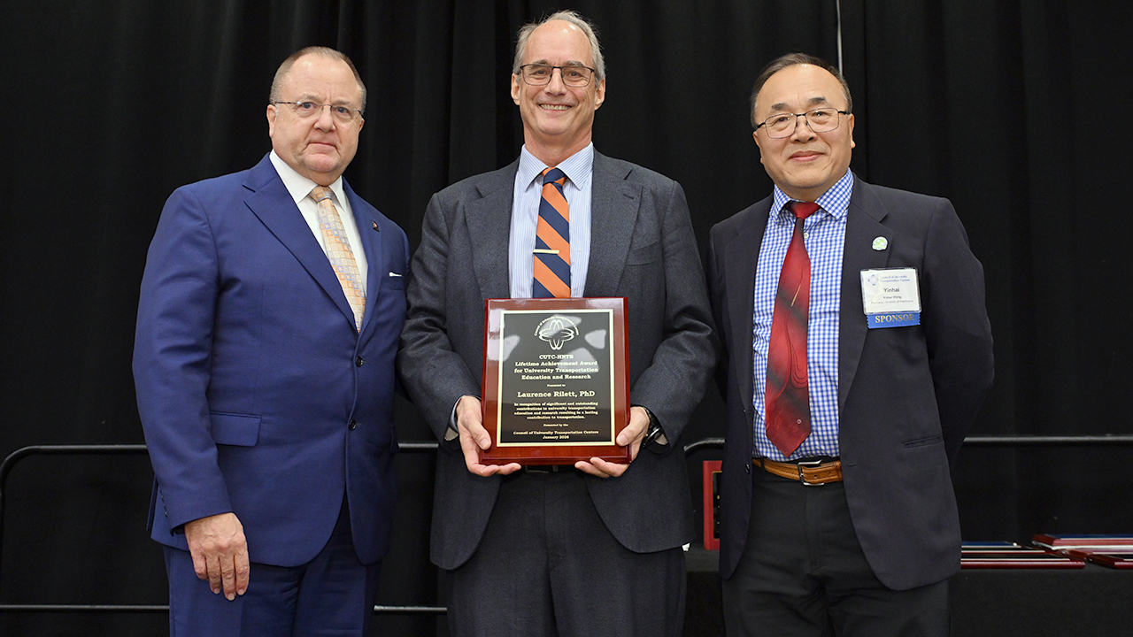 David Noyce, executive associate dean and professor of transportation engineering at the University of Wisconsin–Madison, left, Larry Rilett, director of AUTRI, center, and Yinhai Wang, president of the Council of University Transportation Centers, pose for a photo after Rilett was honored with the CUTC Lifetime Achievement Award for Transportation Professional and Public Service during the organization’s annual awards banquet in January in Washington D.C.