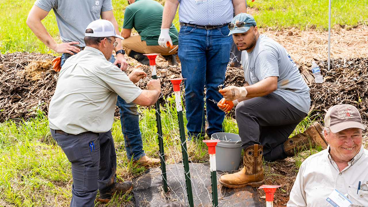 Participants attending Auburn University - Stormwater Research Facility’s Stormwater Week Installer Training construct a fence on Tuesday, May 14 at the facility in Opelika. 