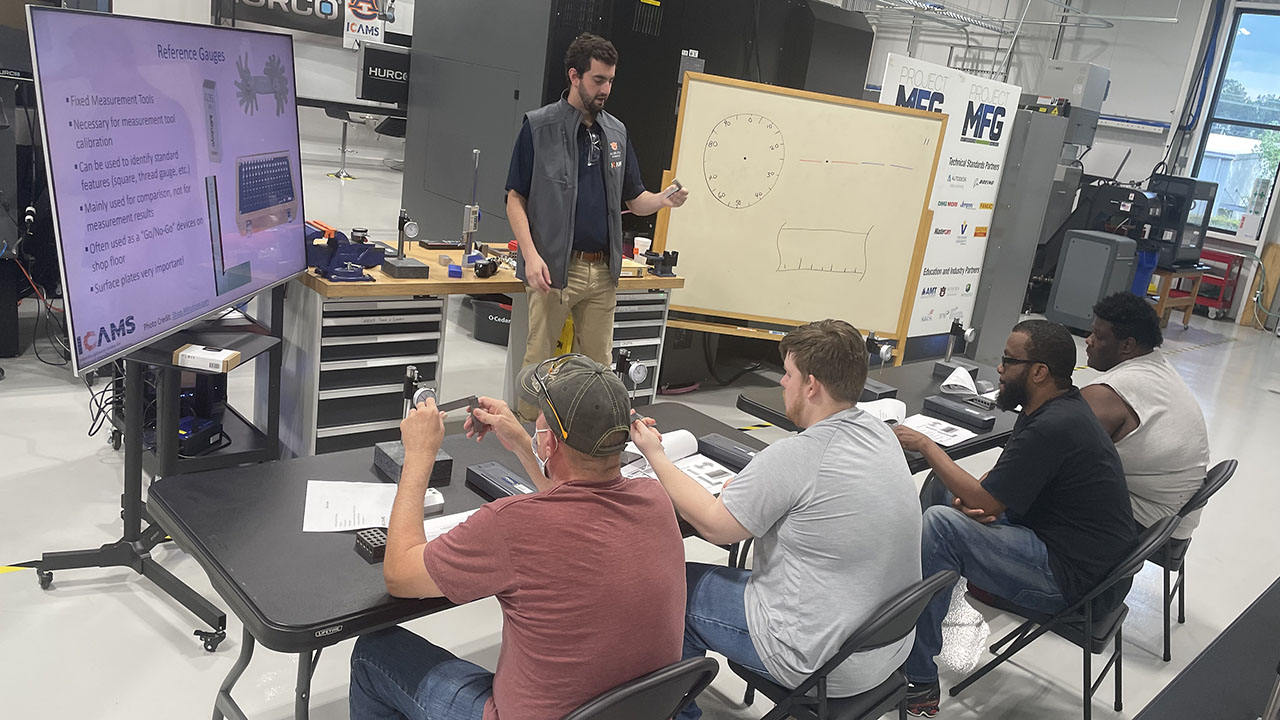ICAMS Research Engineer Sam Snell conducting GE Aerospace assessment training.