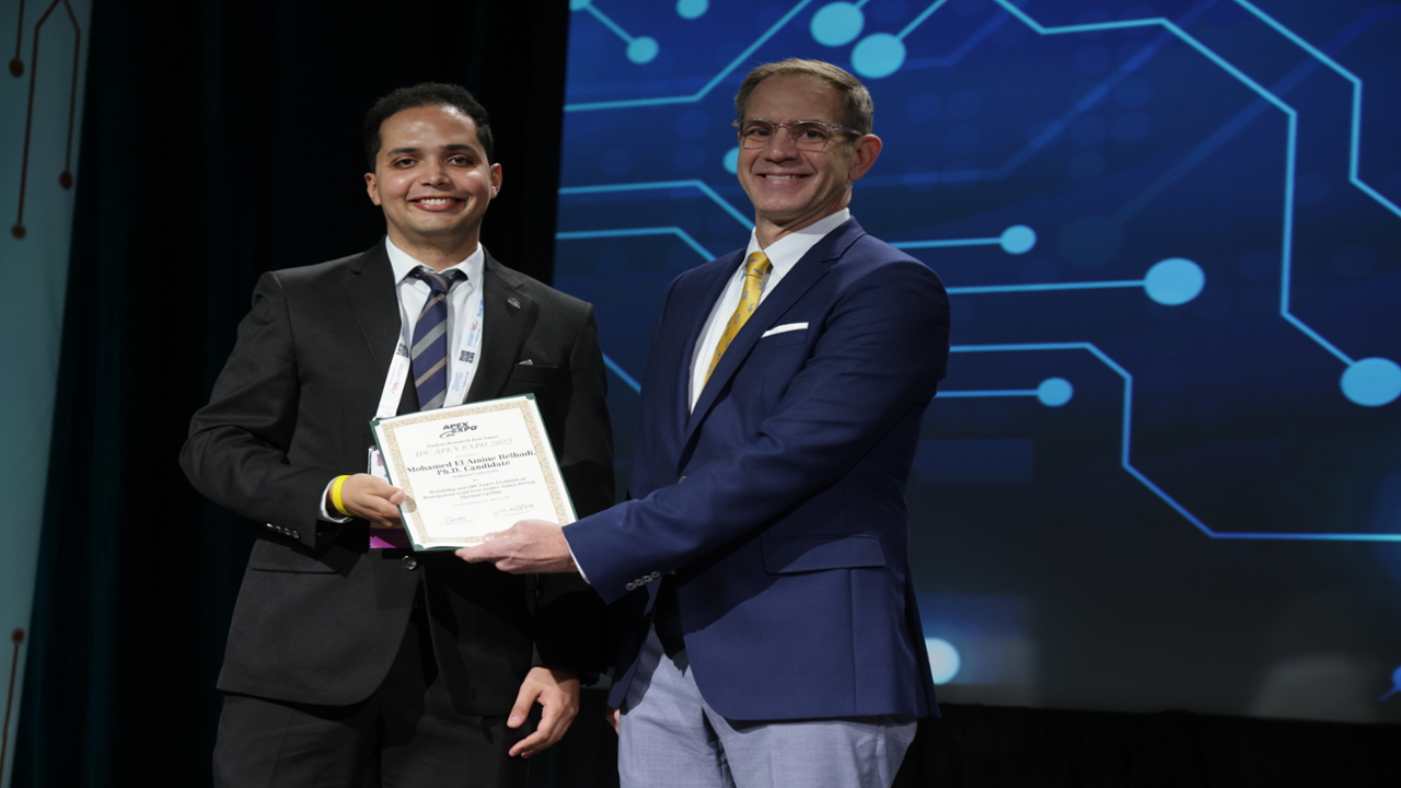 John Mitchell, president of IPC, presented Mohamed El Amine (Wally) Belhadi with the Student Research Award for the best paper at the IPC APEX EXPO 2022.