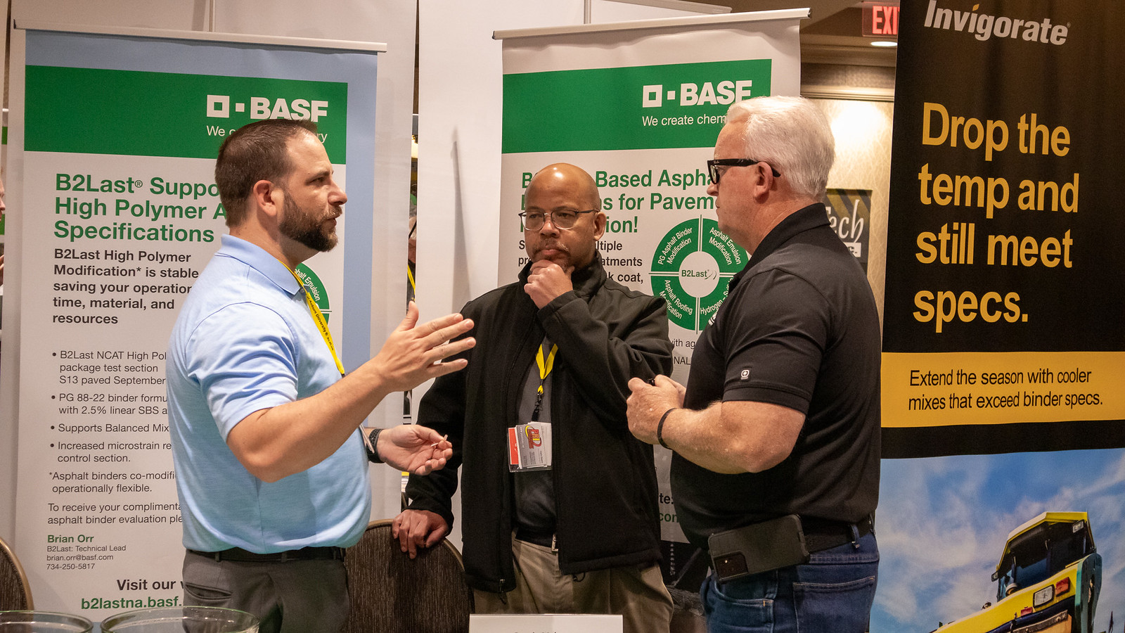 Conference attendees speaking with exhibitors at the NCAT Test Track Conference